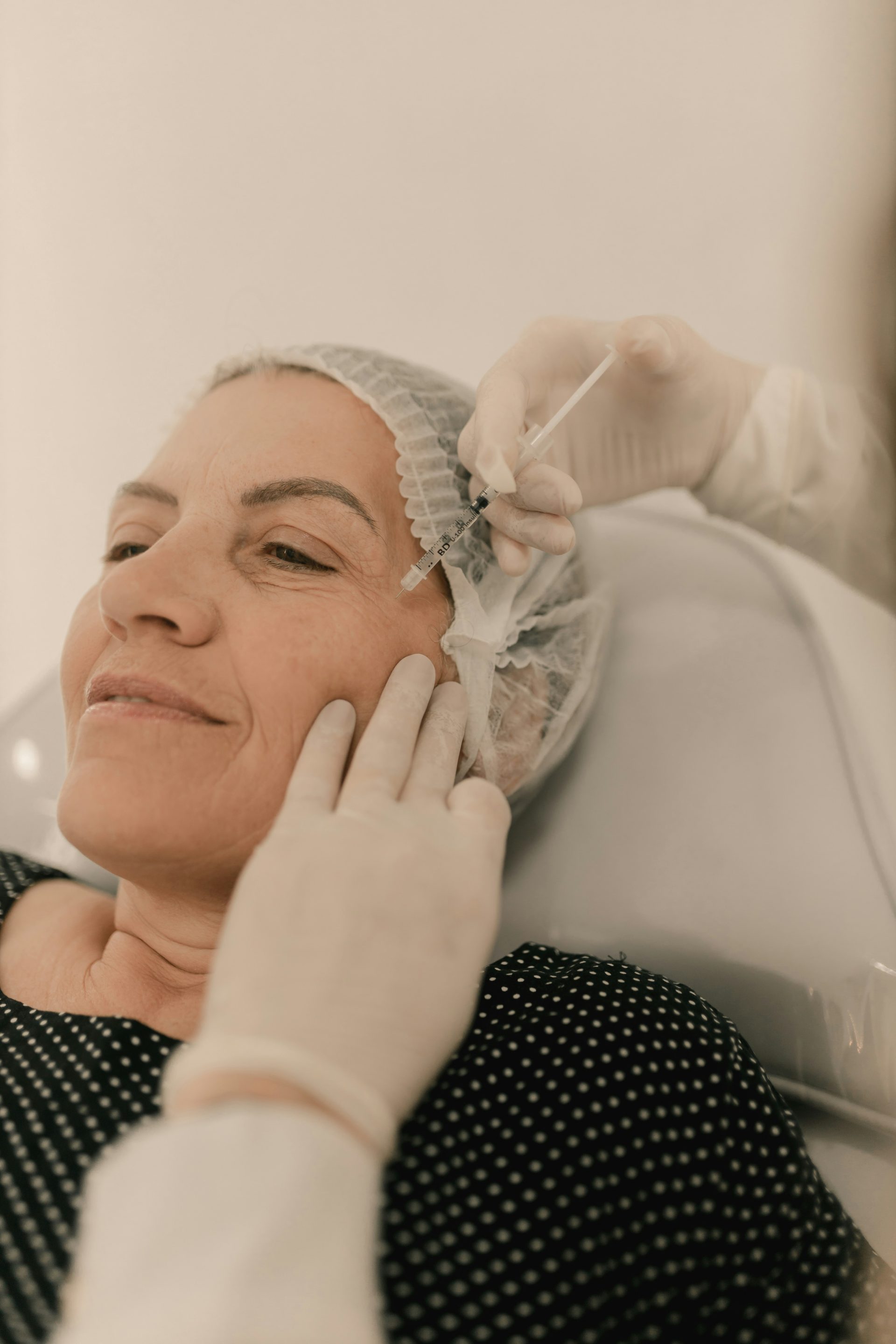 A woman getting her hair done by a hair stylist